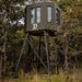 Dillon Manufacturing 6' x 7' Fiberglass Bowhunter Edition Deer Blind in Green on 10' tower in field